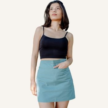 woman stands with green waist apron